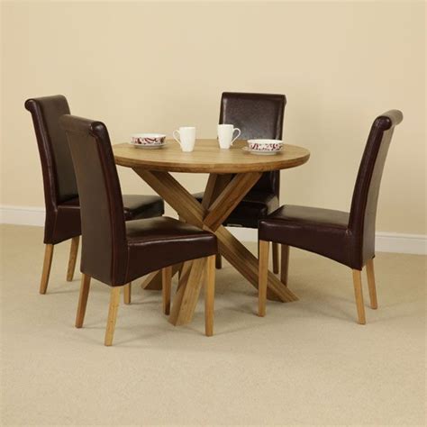 The Solid Oak Round Table With Crossed Legs And Four Brown Scroll Back