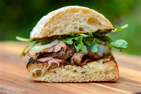 In my take, tender, juicy strips of steak and caramelized onions are covered with melty havarti cheese and nestled in between two buttery slices of baguette. Marinated Flank Steak Sandwiches with Charred Onions ...