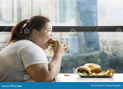 Voracious Fat Woman Eating Burger In The Restaurant Stock Photo Image Of Gluttony