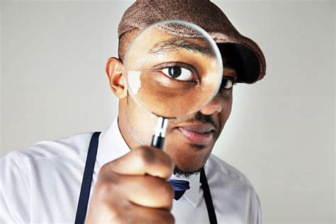Black Man Looking Through A Magnifying Glass Stock Photos Pictures