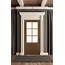 Brown Front Door Surrounded By Decorative Trim  Pella