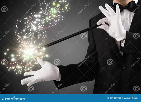 Close Up Of A Magician Creating Sparkles With Magic Wand Stock Photo