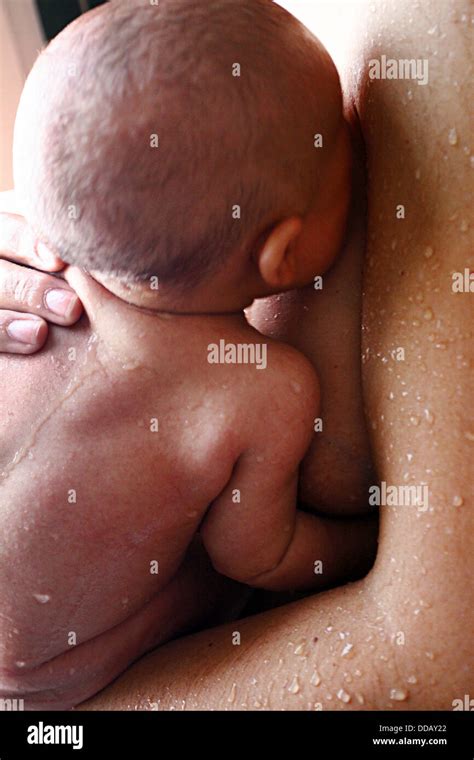 Mother Bathing Her Newborn Baby Stock Photo Alamy