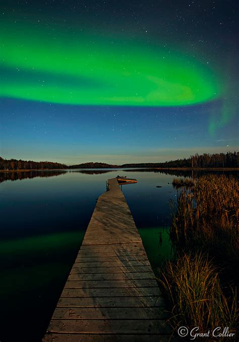 Aurora Borealis And Northern Lights Over Wooden Pier