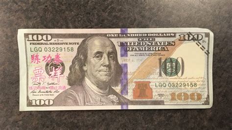 Woman Tried To Pass Off Fake 100 Bills With Pink Chinese Lettering