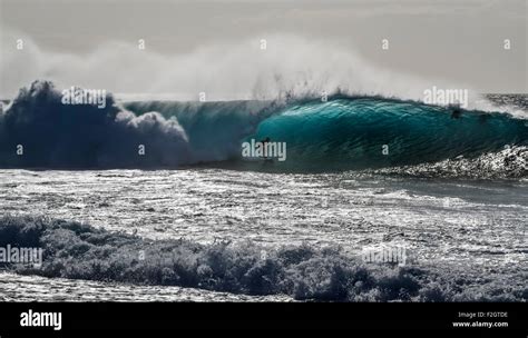 Surfer Silhouette On Back Lit Ocean Wave North Shore Oahu Hawaii Stock