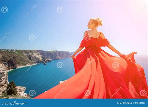 Woman Sea Red Dress Blonde With Long Hair On A Sunny Seashore In A Red