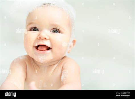 A Baby Girl Bathes In A Bath With Foam And Soap Bubbles Stock Photo Alamy