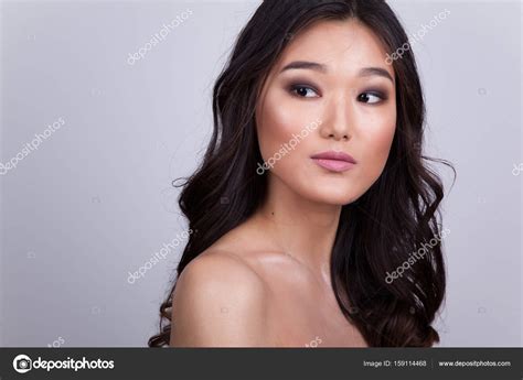 Portrait Of A Beautiful Asian Woman With Naked Shoulders Stock Photo