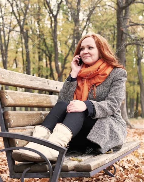 Redhead Girl Talk On Phone And Sitting On A Bench In City Park Fall Season Redhead Girl Girl