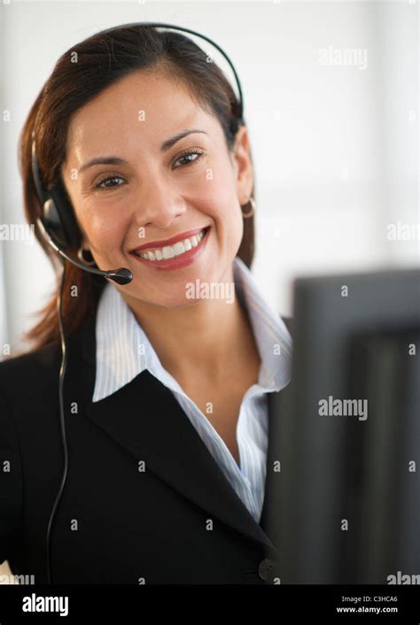 Smiling Female Customer Service Representative With Headset Stock Photo