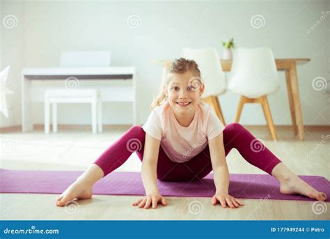 Pretty Happy Child Girl Making Yoga Exercises At Home During