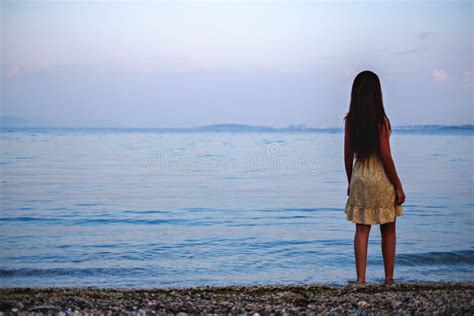 Girl Standing On The Beach And Looking At The Horizon Stock Image