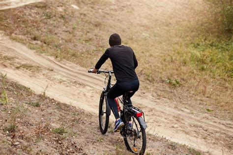 Premium Photo Outdoor Shot Of Male Bike Cyclist Riding Uphill Along