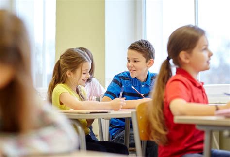 Group Of School Kids Writing Test In Classroom Stock Photo Image Of