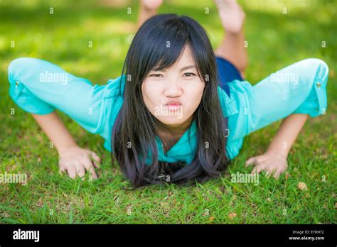 Beautiful Asian Girl Lying Down On Green Grass Beautiful Relaxing Lying In The Garden Stock