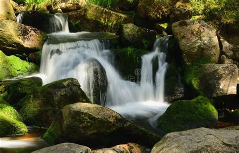 Beautiful Cascade Waterfall Over Green Mossy Rocks In The Forest Stock