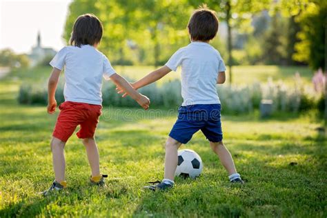 Two Cute Little Kids Playing Football Together Summertime Children