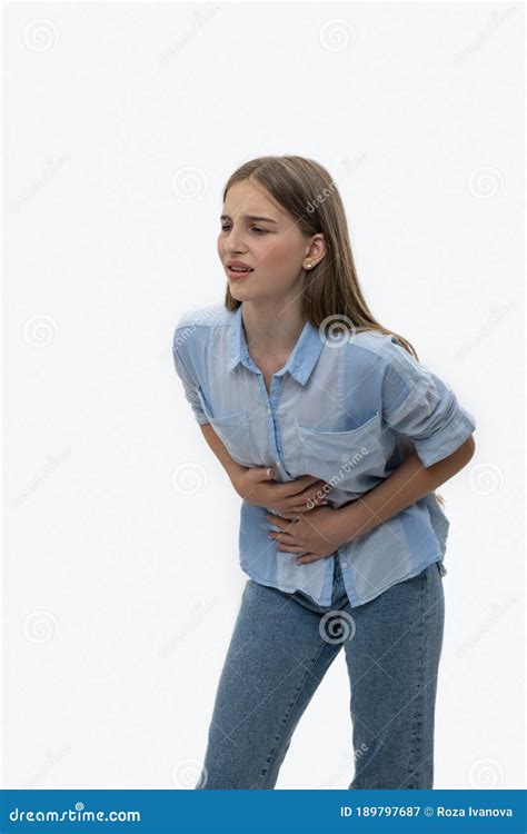 The Young Girl Has A Stomach Ache The Expression On Her Face Shows