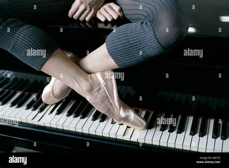 A Female Ballet Dancer Sitting On A Piano Stock Photo 16742609 Alamy