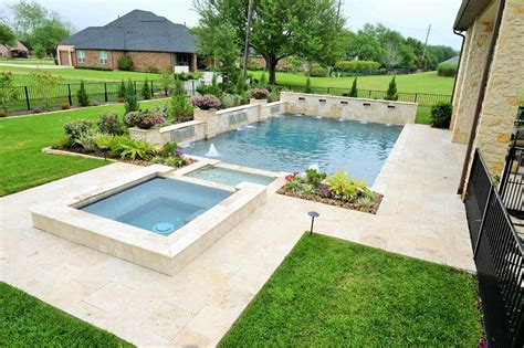 Travertine Pool And Decking Raised Spa That Flows Into A Creek That