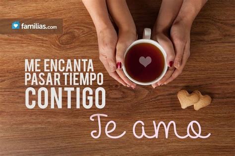a woman holding a cup of coffee with the words te amo written on it