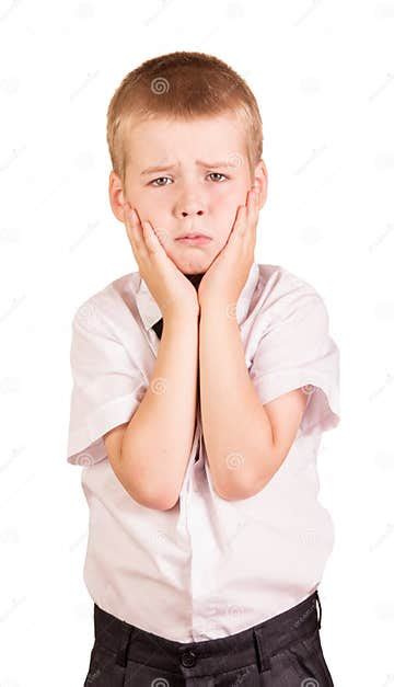 Unhappy Boy Covers His Cheeks Hands Isolated On White Stock Image