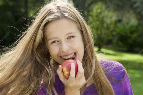 Smiling Girl Eating Apple In Park Stock Image F0065338 Science Photo Library