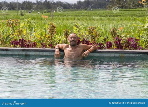 Portrait Of A Attractive Man In Swimming Pool Near Rice Terrace On The