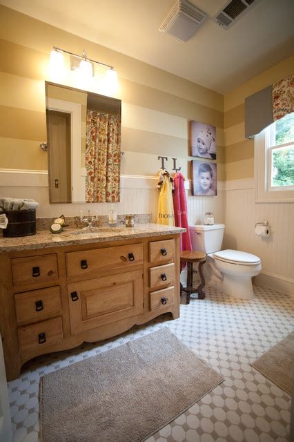 Turquoise kid;s bathroom features walls painted turquoise blue lined with an extra wide single washstand accented with raised panel doors topped with white and gray quartzite countertops mimicking marble under a white framed vanity mirror. 22 Adorable Kids Bathroom Decor Ideas - Style Motivation