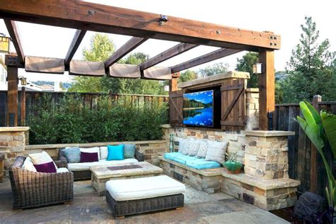 A mediterranean style covered outdoor patio in dallas, texas offers two seating areas, one centered around a fireplace with overhead television. DIY Covered Patio Ideas - DECOREDO