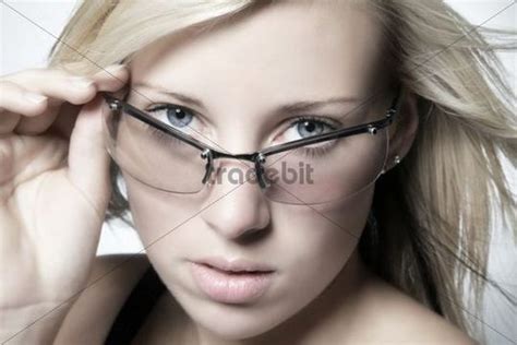 Portrait Of A Young Blonde Woman Wearing Glasses Download People