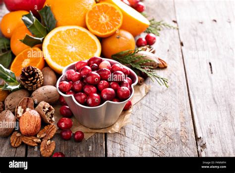 Fall And Winter Ingredients Still Life With Oranges Cranberry Nuts