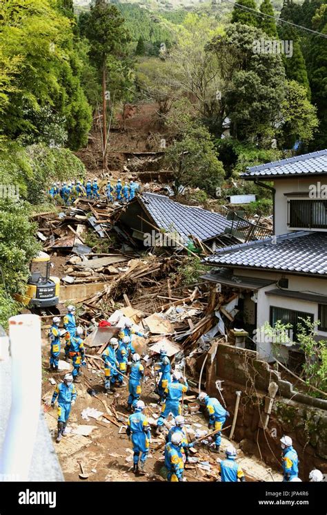 rescue workers search for survivors in the rubble of a house in the village of minamiaso