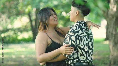 video „two latin lesbian women hold close in park showcasing love and diversity ideal for