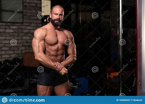 Muscular Man Flexing Muscles In Gym Stock Image Image Of Handsome
