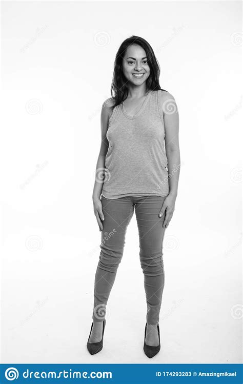 Full Body Shot Of Happy Beautiful Woman Smiling While Standing Against