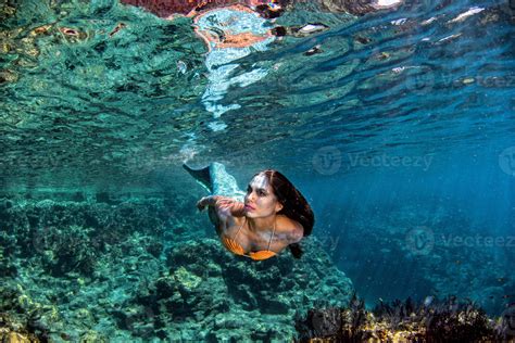 Mermaid Swimming Underwater In The Deep Blue Sea 12204242 Stock Photo