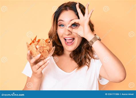 Young Beautiful Caucasian Woman Holding Nachos Potato Chips Smiling Happy Doing Ok Sign With