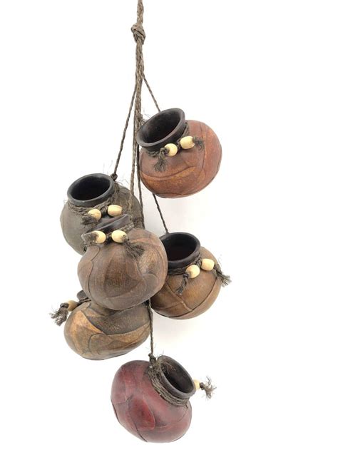 A kind of organic version for cookware. Lot - Vtg Mexican Hanging Leather Wrapped Clay Pots