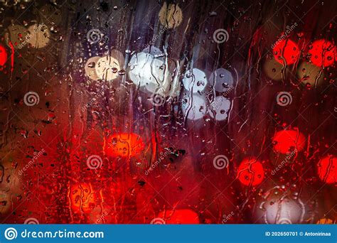 Blurred Traffic Lights And Rain Drops On Window Abstract Bokeh With