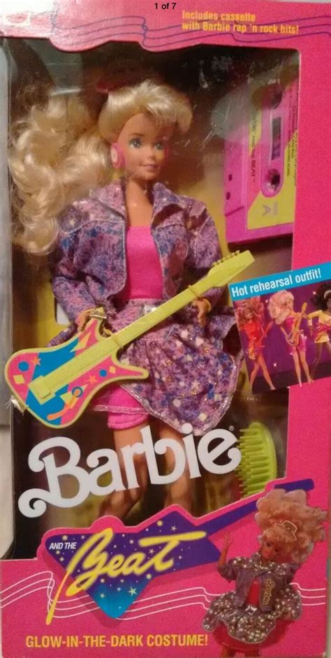 the barbie doll is wearing a pink dress and holding a guitar