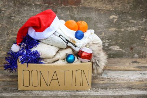 Donation Box With Winter Clothes And With Christmas Decorations T