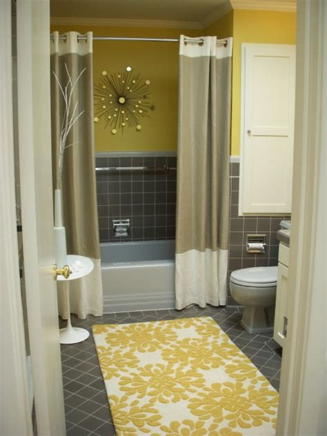 A modern, yellow bathroom makeover that uses a bright and bold wallpaper as a neutral somehow. 2 shower curtains for the bath - FaveThing.com
