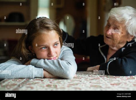 Old Woman Comforting A Crying Little Girl Granddaughter Stock Photo Alamy