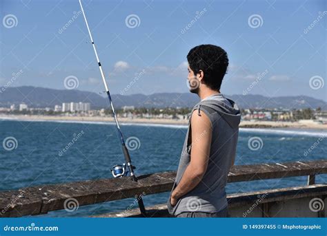 Young Fisherman Looking Over The Ocean At A Tropical Resort Stock Image