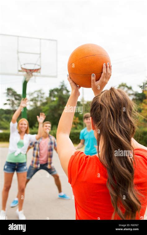 Group Of Happy Teenagers Playing Basketball Stock Photo Alamy