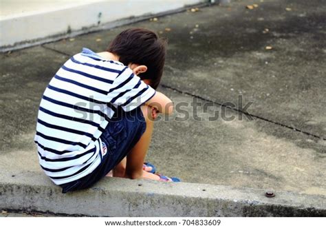 Sad Boy Sitting On Street Alone Stock Photo Edit Now 704833609