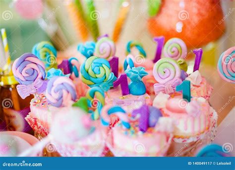 Pink And Blue Cupcakes With Colored Lollypops For Candy Bar Stock Image