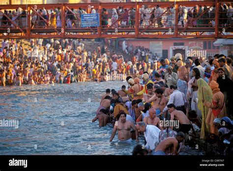 Hindu Pilgrims Taking A Holy Bath In The Ganges River During The Kumbh